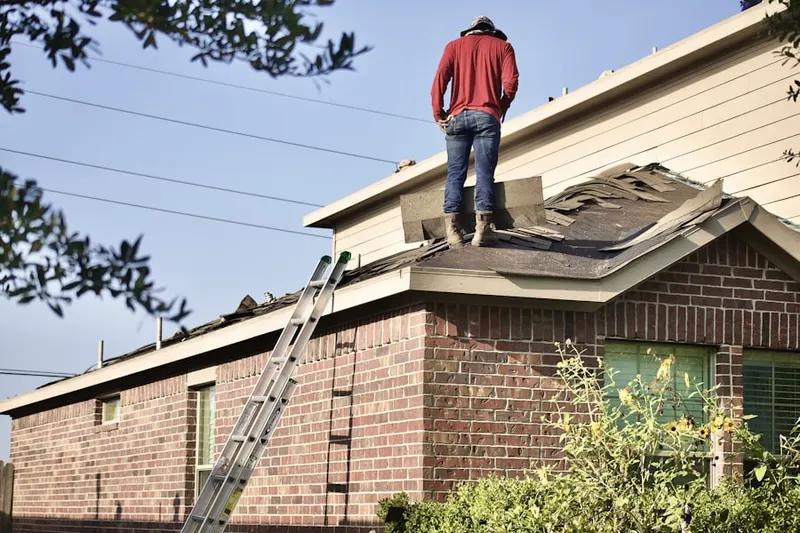 Professional roofer working on a residential roof in Pawcatuck